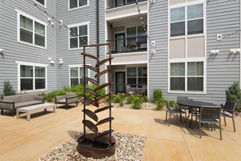a spiral sculpture in the courtyard of an apartment building  at Watermark at Harvest Junction, Colorado, 80501